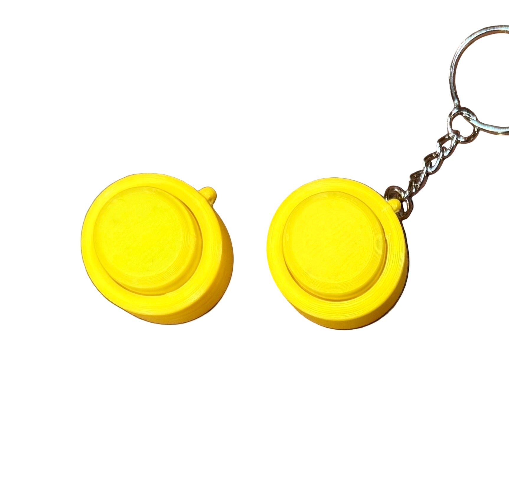 Snappy™ Click in yellow with and without keychain. Portable mechanical keyboard fidget for on-the-go tactile fun.