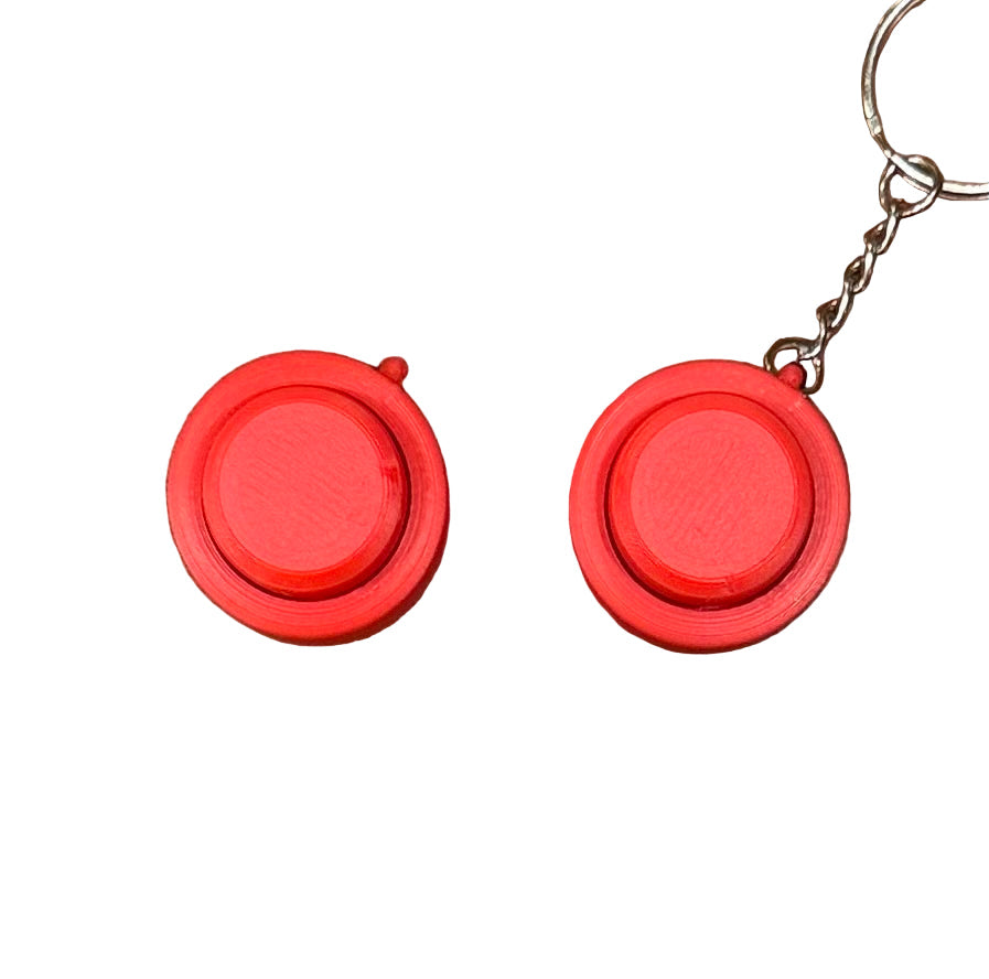 Red Snappy™ Click portable fidget toy displayed with and without keychain. Compact mechanical keyboard-style fun.