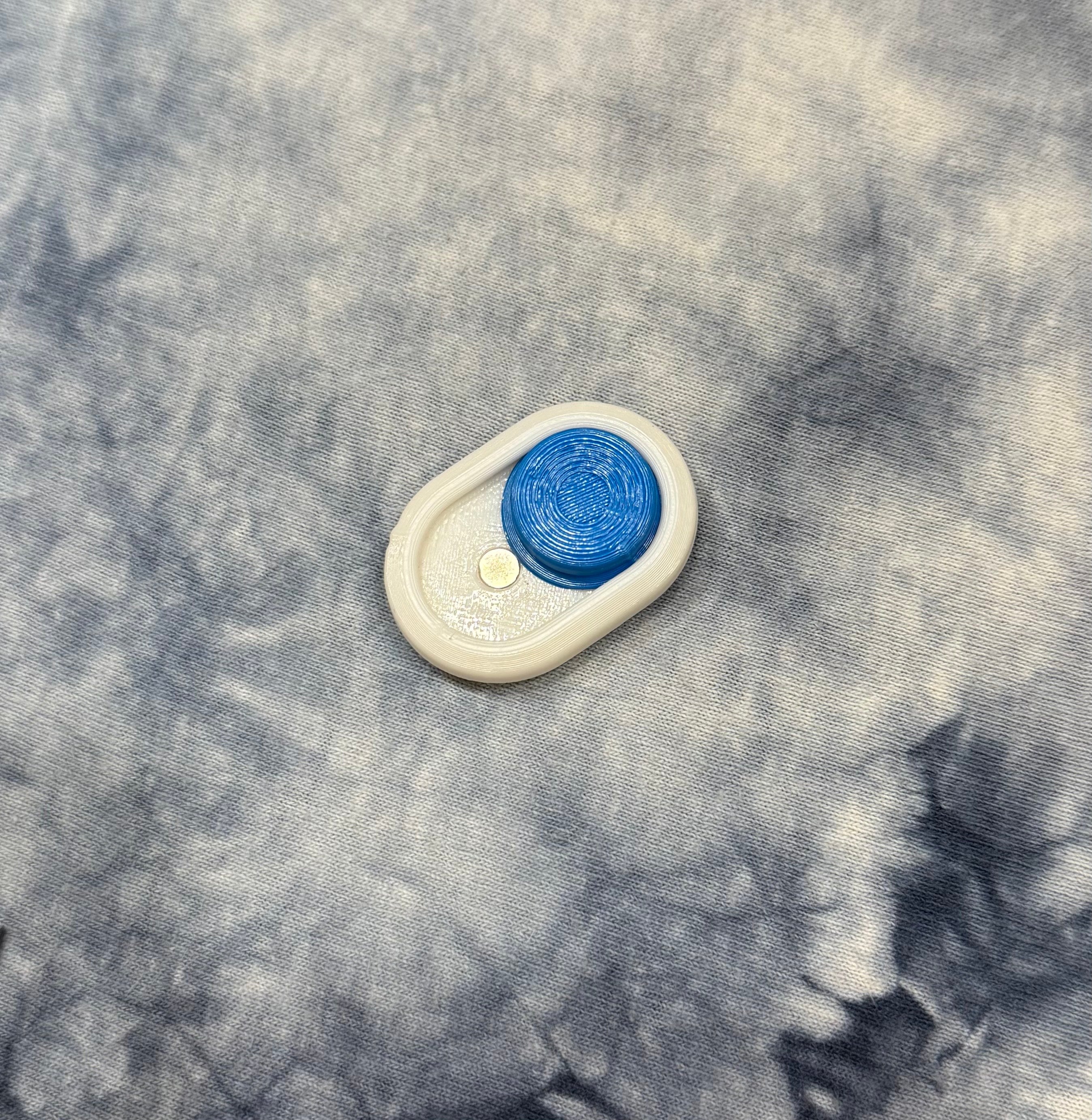 Minimalist Snow Cap Keychain featuring a blue pressable cap and white body, designed for portability and daily carry.